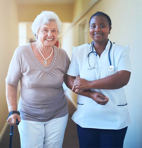 elderly woman and a nurse smiling