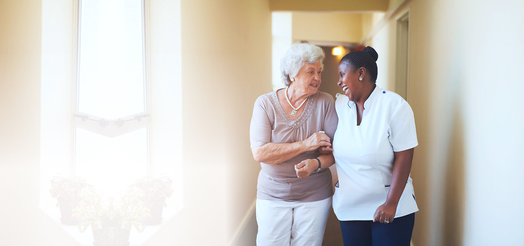 elderly woman and her caregiver talking